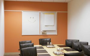 The boardroom of a business that uses a computer network and Sage is empty because the staff left the meeting early and happy thanks to smoother workflow systems.